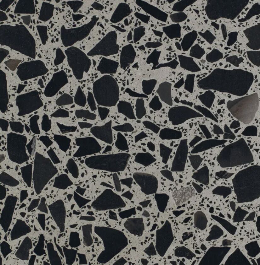 a close-up of terrazzo Trochetto with black chunks ad grey backdrop